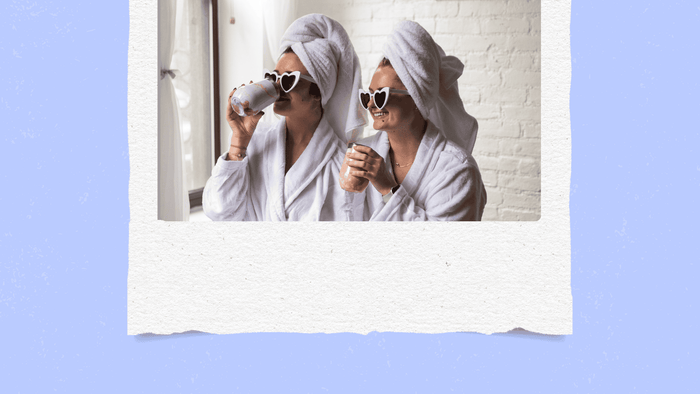 two girls with towels on their heads and robes on 